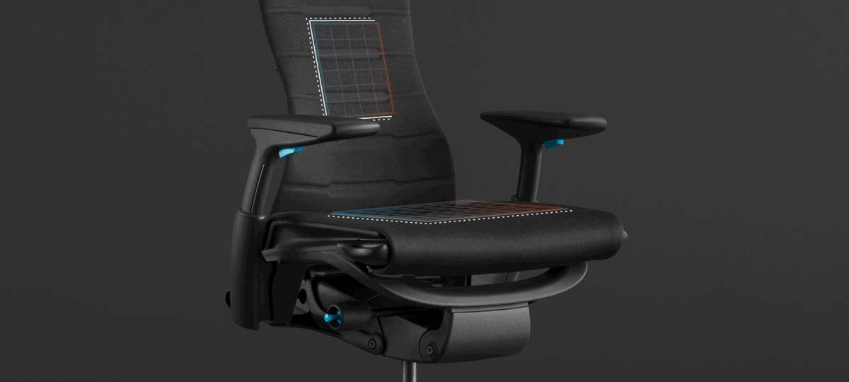 Skriftbillede af en sort og blå Embody-gamingstol fra Herman Miller, overlejret med hvid grafik, der fremhæver sædet og ryggen.