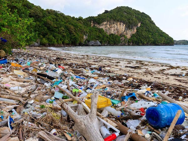 Foto af en strand dækket af plast, der viser, hvor Herman Miller genvinder plasten til brug i nye produkter